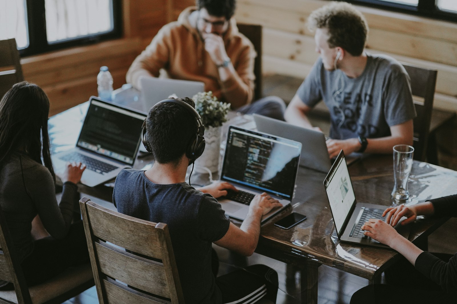 Team collaborating around laptops in an open workspace